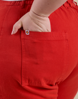 Close up of Ashley's hand in the back pocket of Work Pants in Mustang Red