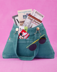 Overall Handbag in Marine Blue. Magic Kingdom brochures inside main compartment