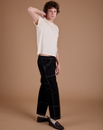 Carpenter Jeans in Black and the Organic Vintage Tee in Vintage Tee Off-White side view on Quinn