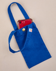 Phone tucked into royal blue Cell Phone Tote