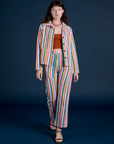 Alex is wearing Stripe Work Jacket in Rainbow Stripe and matching Work Pants