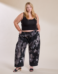 Juliet is wearing Magic Waters Drop Pocket Pants in Ink Blot and black Cropped Tank