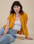 Alex is wearing Pantry Button-Up in Mustard Yellow