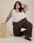 Work Pants in Espresso Brown and Tank Top in Vintage Tee Off-White worn by Sam