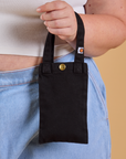 Cell Phone Tote in black held by model