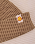 Ribbed Beanie in Desert Brown close up of sun baby tag