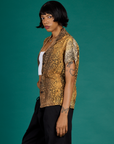Angled side view of the Leopard Pantry Button Up on Kira