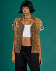Kira is wearing the Leopard Pantry Button Up