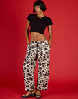 Kira is 5'10" and wearing XS Cow Drop Pocket Pant with Black Cropped Baby Tee