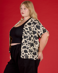 Angled side view of Juliet wearing the Cow Pantry Button Up