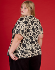 Angled back view of Juliet wearing the Cow Pantry Button Up
