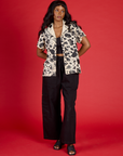 Kandia is 5'3" and wearing XXS Cow Pantry Button Up with the Black Drop Pocket Pants