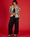 Kira wearing the Cow Pantry Button Up with the Black Cropped Tank and Black Drop Pocket Pants