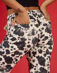 Close up of Kira's hands in the back pockets of the Cow Work Pant