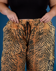 Close up of Juliet's hands on the waistband of the Tiger Drop Pocket Pant