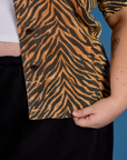 Close up on the buttons and hem of the Tiger Pantry Button Up