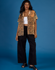 Kandia is wearing the Tiger Pantry Button Up open with the Vintage Tee White Cropped Tank underneath and Black Drop Pocket Pants