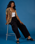 Kandia wearing the Tiger Pantry Button Up open with the Vintage Tee White Cropped Tank and Black Drop Pocket Pants