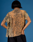 Back view of Kira wearing the Tiger Pantry Button Up