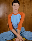 Alex wearing the Baby Blue/Orange Colorblock Raglan Tee