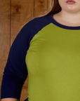 Close up he Gross Green/Navy Colorblock Raglan Tee's sleeve worn by Juliet
