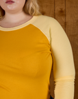 Close up of the Mustard Yellow/Butter Raglan Tee on Juliet