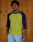 Isaac wearing the Gross Green/Navy Colorblock Raglan Tee