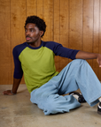 Isaac wearing the Gross Green/Navy Colorblock Raglan Tee and Light Wash Denim Drop Pocket Pants