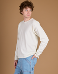 Angled side view of Quinn wearing the Vintage Tee White Long Sleeve Burly Tee