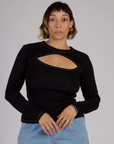 Tiara is 5'4" and wearing XS Black Porthole Long Sleeve Tee