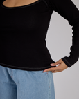 Close up of the Black Porthole Long Sleeve Tee's hem worn by Tiara