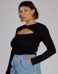 Angled side view of Tiara wearing the Black Porthole Long Sleeve Tee