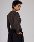 Angels back view of the Espresso Brown Long Sleeve Porthole Tee on Mika