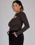 Side view of Tiara wearing the Espresso Brown Long Sleeve Porthole Tee