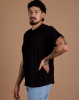 Angled front view of Burly Tee in Basic Black on Jesse