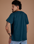 Angled back view of Burly Tee in Lagoon on Jesse