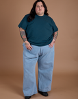 Sam is 5'10" and wearing 2XL Burly Tee in Lagoon paired with light wash Indigo Wide Leg Trousers