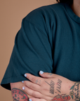 Burly Tee in Lagoon shoulder and sleeve close up on Sam