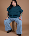 Burly Tee in Lagoon and light wash Indigo Wide Leg Trousers on Sam