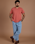 Jesse is 5'8" and wearing S Burly Tee in Raspberry Sorbet paired with light wash Carpenter Jeans