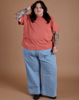 Sam is 5'10" and wearing 2XL Burly Tee in Raspberry Sorbet paired with light wash Indigo Wide Leg Trousers