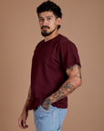 Angled front view of Burly Tee in Red Wine on Jesse