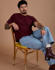 Jesse is wearing Burly Tee in Red Wine and light wash Carpenter Jeans