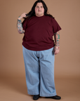 Burly Tee in Red Wine and light wash Indigo Wide Leg Trousers on Sam