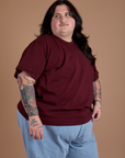 Angled front view of Burly Tee in Red Wine on Sam