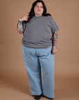 Sam is 5'10" and wearing 2XL Burly Tee in Washed Grey paired with light wash Indigo Wide Leg Trousers