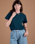 Alex is wearing Burly Tee in Lagoon tucked into light wash Wide Leg Trousers