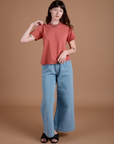 Alex is wearing aBurly Tee in Raspberry Sorbet and light wash Indigo Wide Leg Trousers
