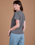 Angled back view of Burly Tee in Washed Grey on Alex