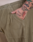 Close up of Sam's hand in the front pocket of Corduroy Drop Pocket Cargo Pants in Khaki Grey